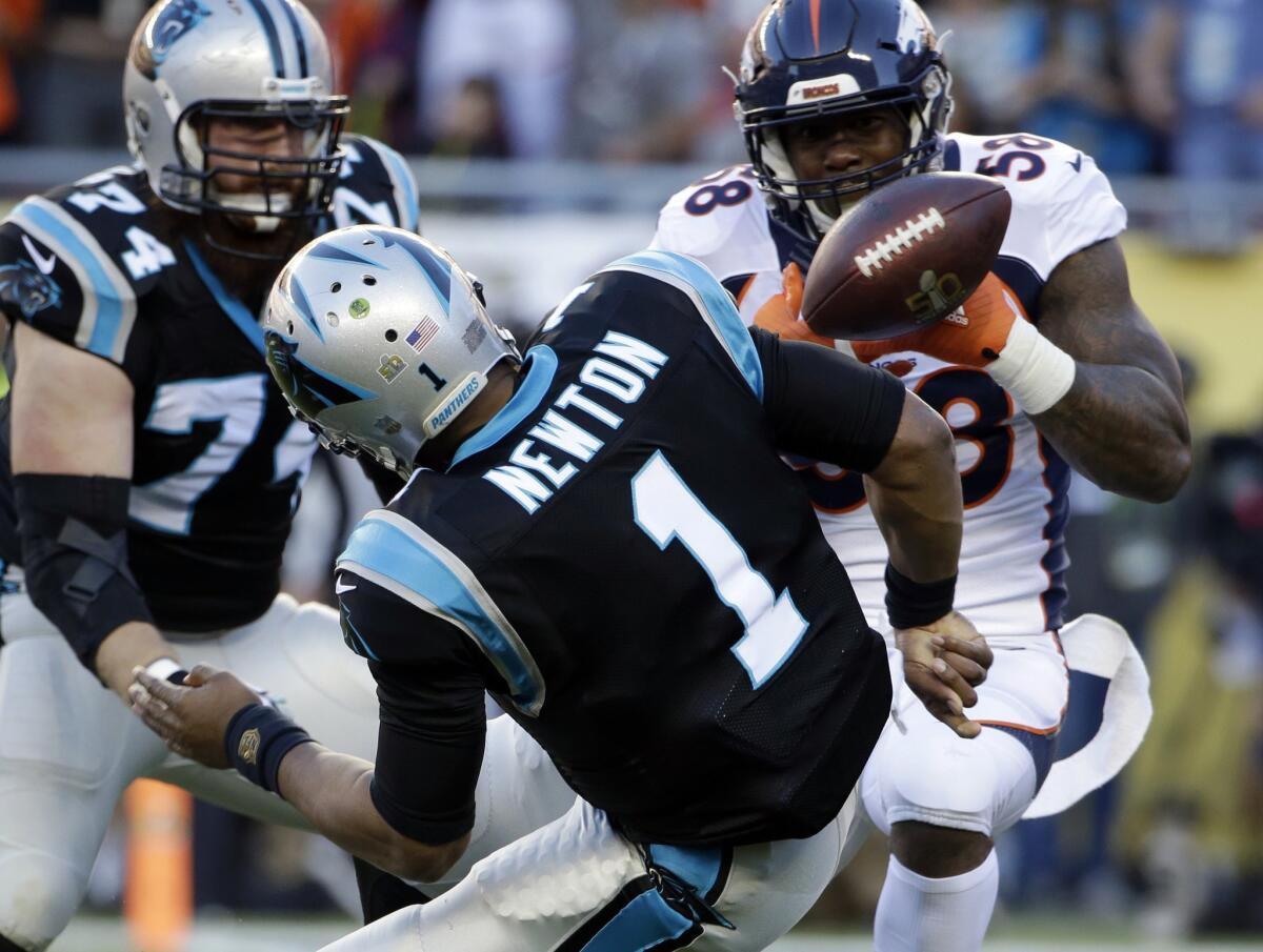 Broncos linebacker Von Miller (58) strips the ball from Panthers quarterback Cam Newton, leading to a fumble recovery for a touchdown by Malik Jackson (not pictured).