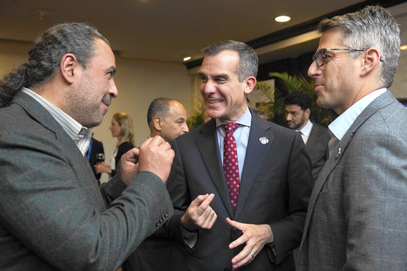 ANOC President Sheikh Ahmad Al-Fahad Al-Sabah, left, speaks with Casey Wasserman, LA 2024 Chairman, right, and Los Angeles Mayor Mayor Eric Garcetti, at the reception before the XX ANOC General Assembly 2015 on Oct. 27 in Washington, DC.