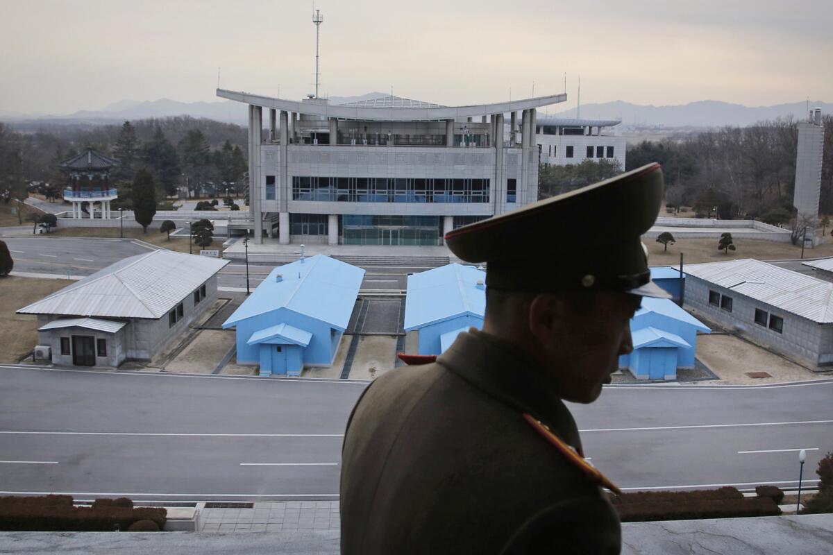 A North Korean army officer looks out at the Demilitarized Zone.