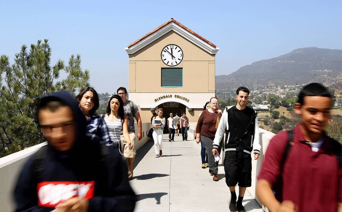 Students walk along a bridge toward a parking structure at Glendale Community College. Thousands of community college classes will be restored, thanks to the passage of Proposition 30.