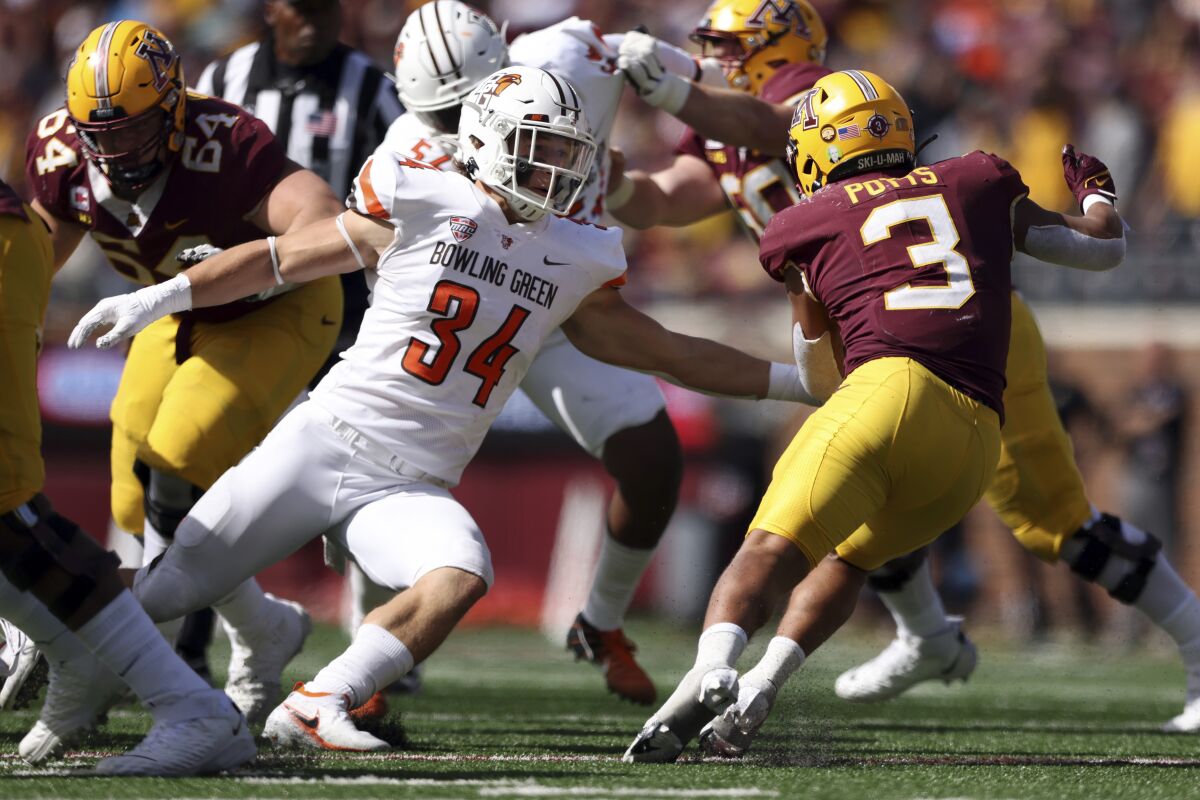 Minnesota running back Treyson Potts (3) avoids a tackle by Bowling Green linebacker Brock Horne (34) during the second half of an NCAA college football game Saturday, Sept. 25, 2021, in Minneapolis. Bowling Green won 14-10. (AP Photo/Stacy Bengs)
