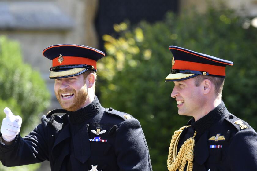 FILE - Britain's Prince Harry, left, reacts as he walks with his best man, Prince William the Duke of Cambridge, as they arrive for the the wedding ceremony of Prince Harry and Meghan Markle at St. George's Chapel in Windsor Castle in Windsor, near London, England, Saturday, May 19, 2018. Prince Harry has said he wants to have his father and brother back and that he wants “a family, not an institution,” during a TV interview ahead of the publication of his memoir. The interview with Britain’s ITV channel is due to be released this Sunday. (Ben Birchhall/pool photo via AP, File)