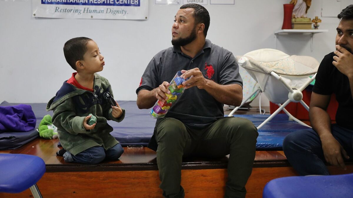 A Honduran father and son at the Catholic Charities Humanitarian Respite Center in McAllen, Texas. The Trump administration is seeking court permission to hold more immigrant families in detention centers for extended periods after they are caught illegally crossing the border.