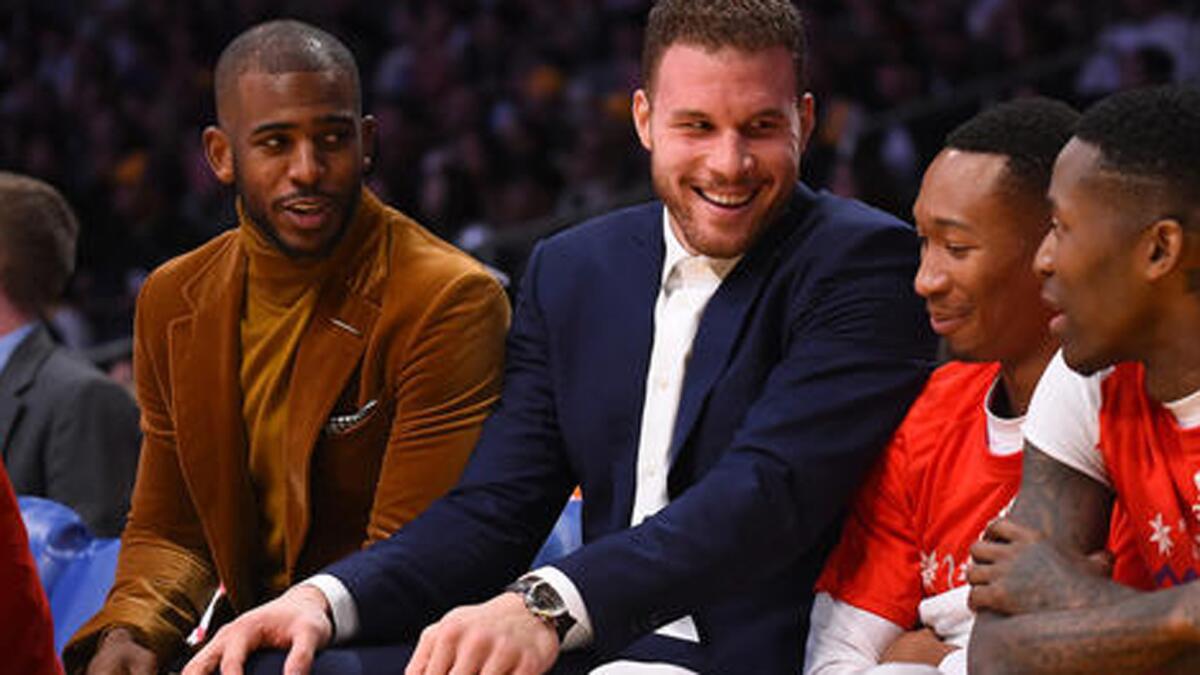 Chris Paul and Blake Griffin talk with Wesley Johnson and Jamal Crawford on the Clippers bench during the first half of their Christmas evening game against the Lakers.