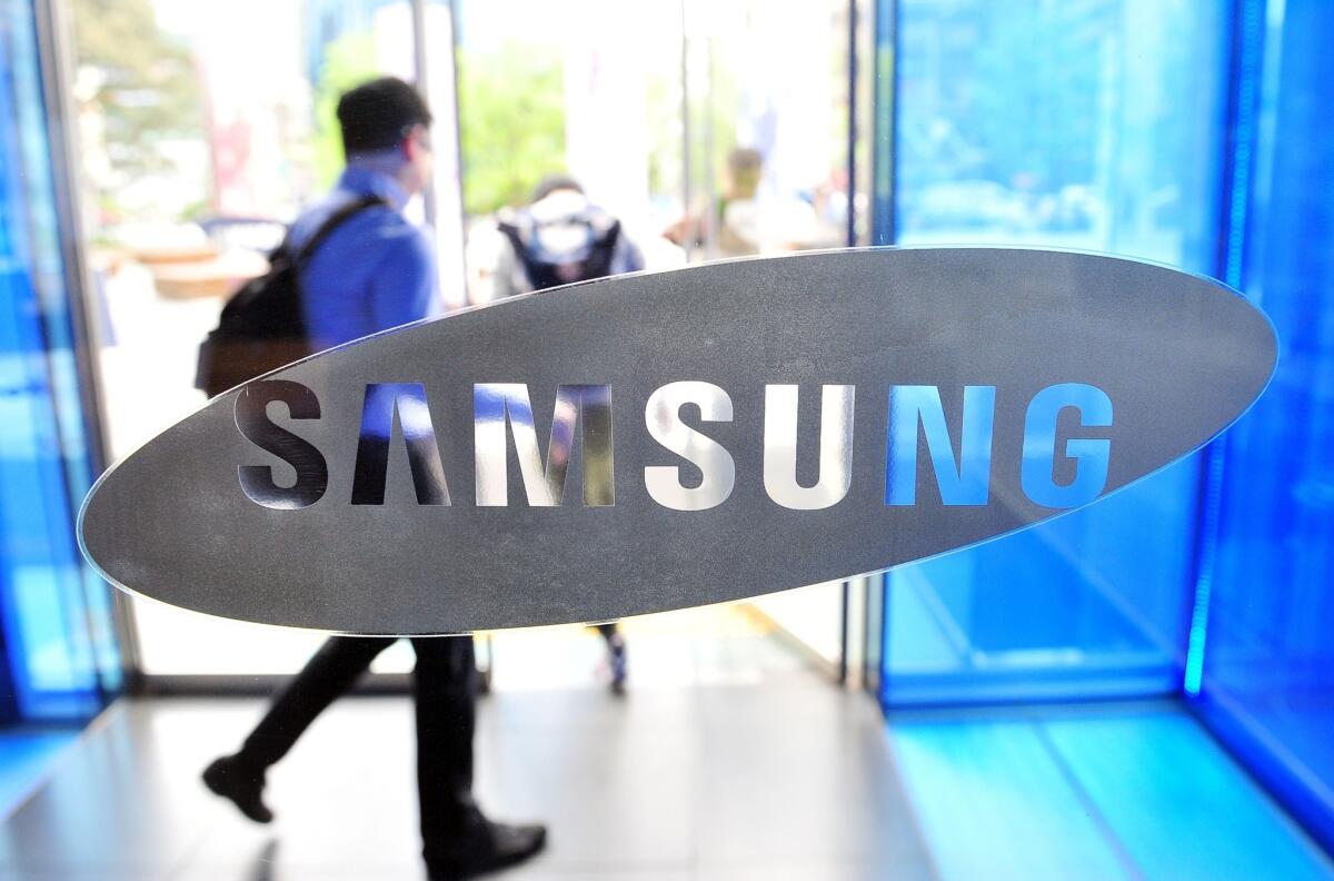 A visitor walks past a logo of Samsung Electronics at the company's headquarters in Seoul on April 29.
