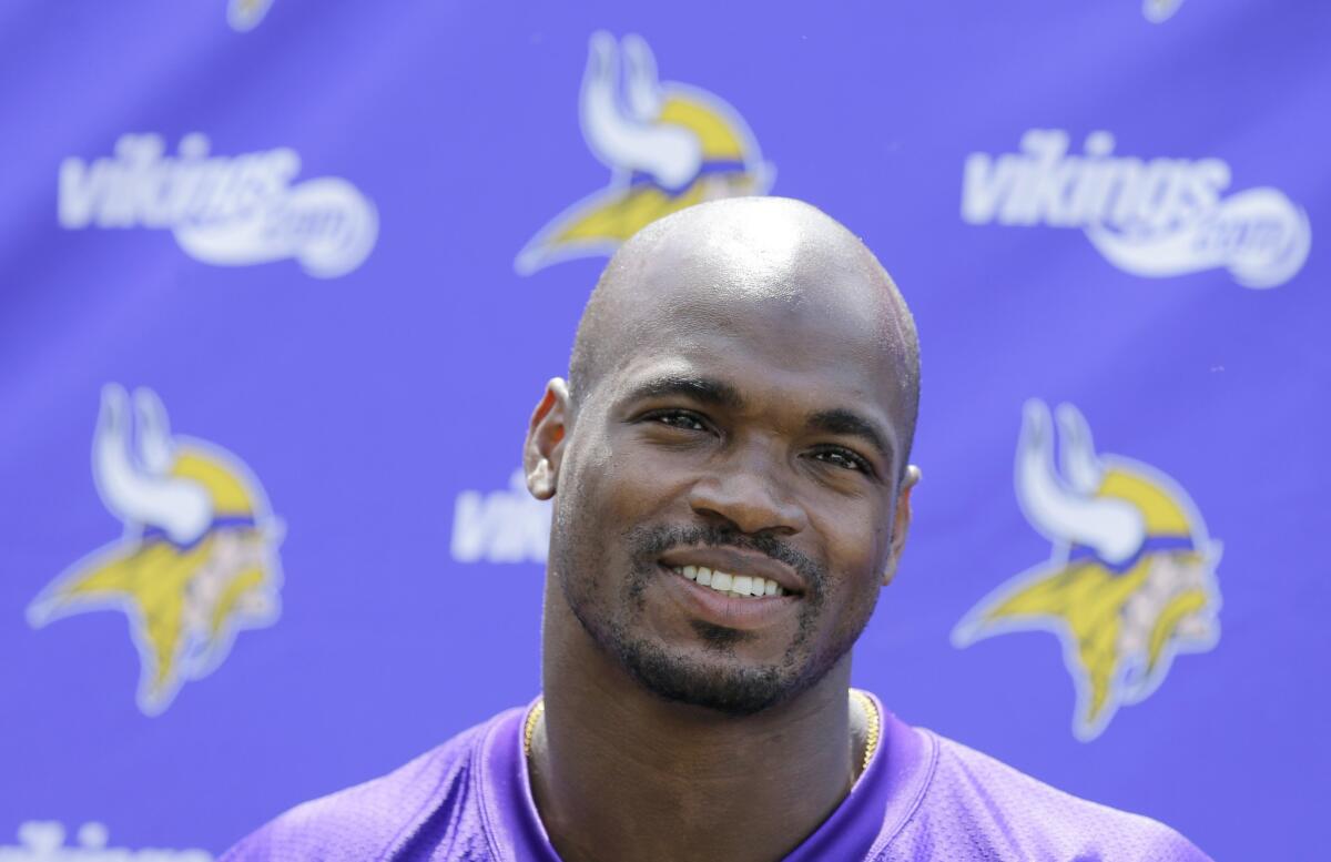 Minnesota running back Adrian Peterson talks with members of the media after the Vikings' minicamp in Eden Prairie, Minn. on June 18.