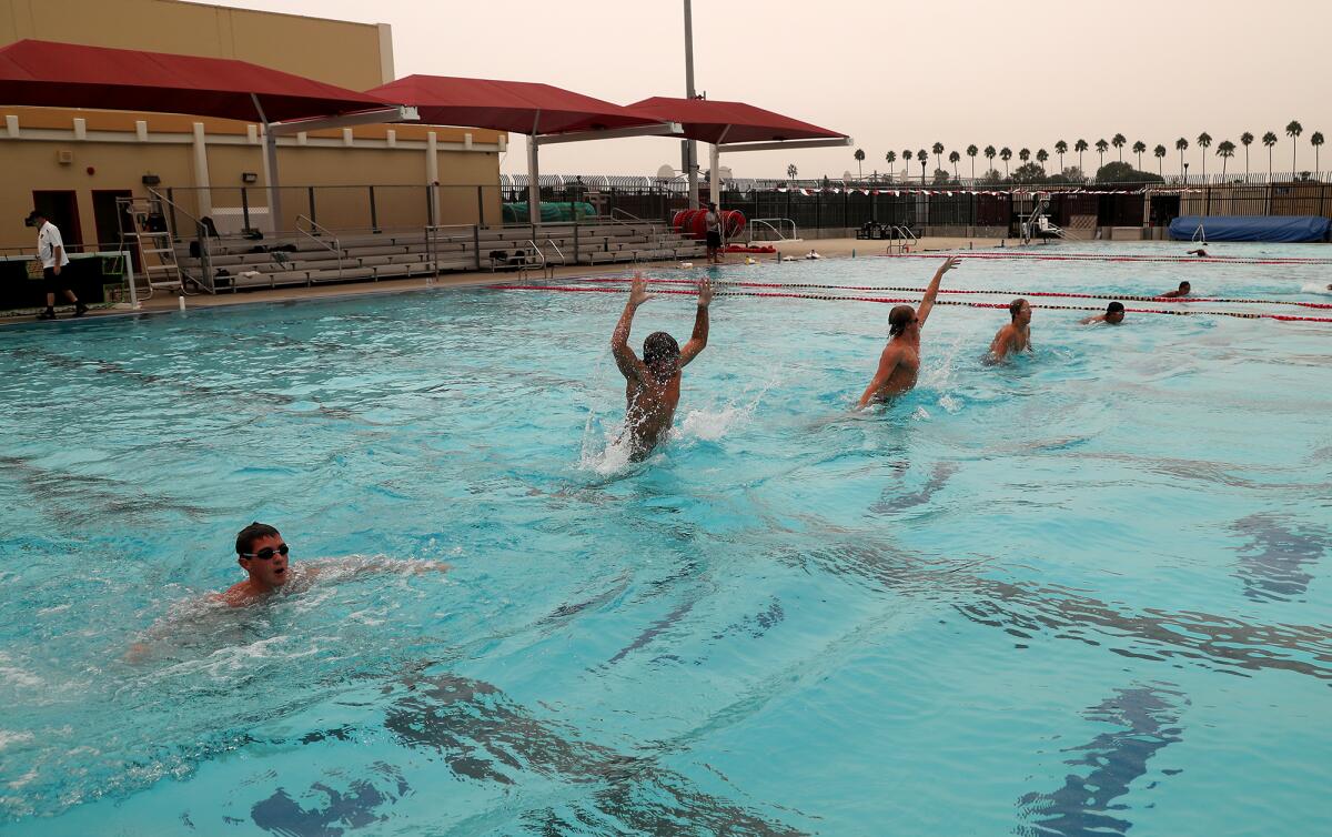 High school boys' water polo players work out Thursday at Estancia High School in Costa Mesa. 