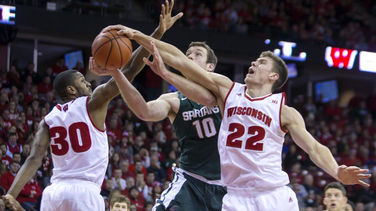 Wisconsin's Ethan Happ (22) blocks a shot by Michigan State's Matt Costello (10) during the first half Sunday.