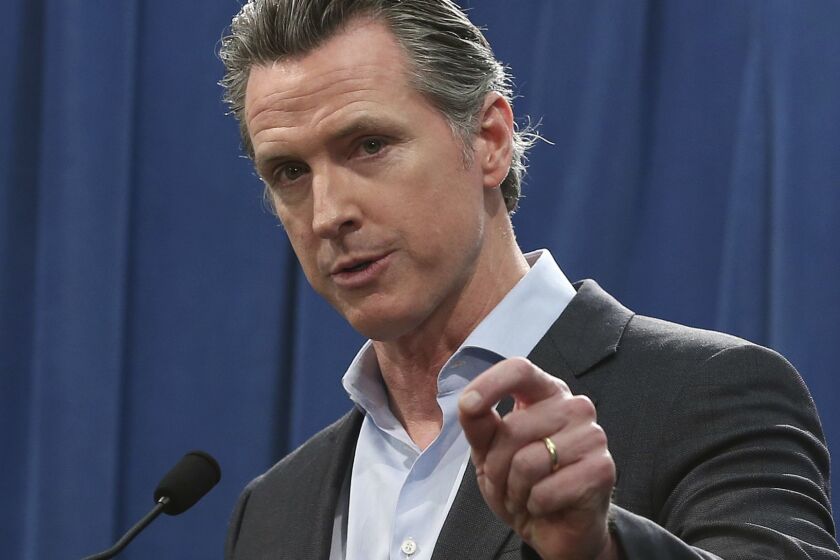 California Gov. Gavin Newsom discusses his decision to withdraw National Guard troops from the nation's southern border and changing their mission, during a Capitol news conference Monday, Feb. 11, 2019, in Sacramento, Calif. (AP Photo/Rich Pedroncelli)