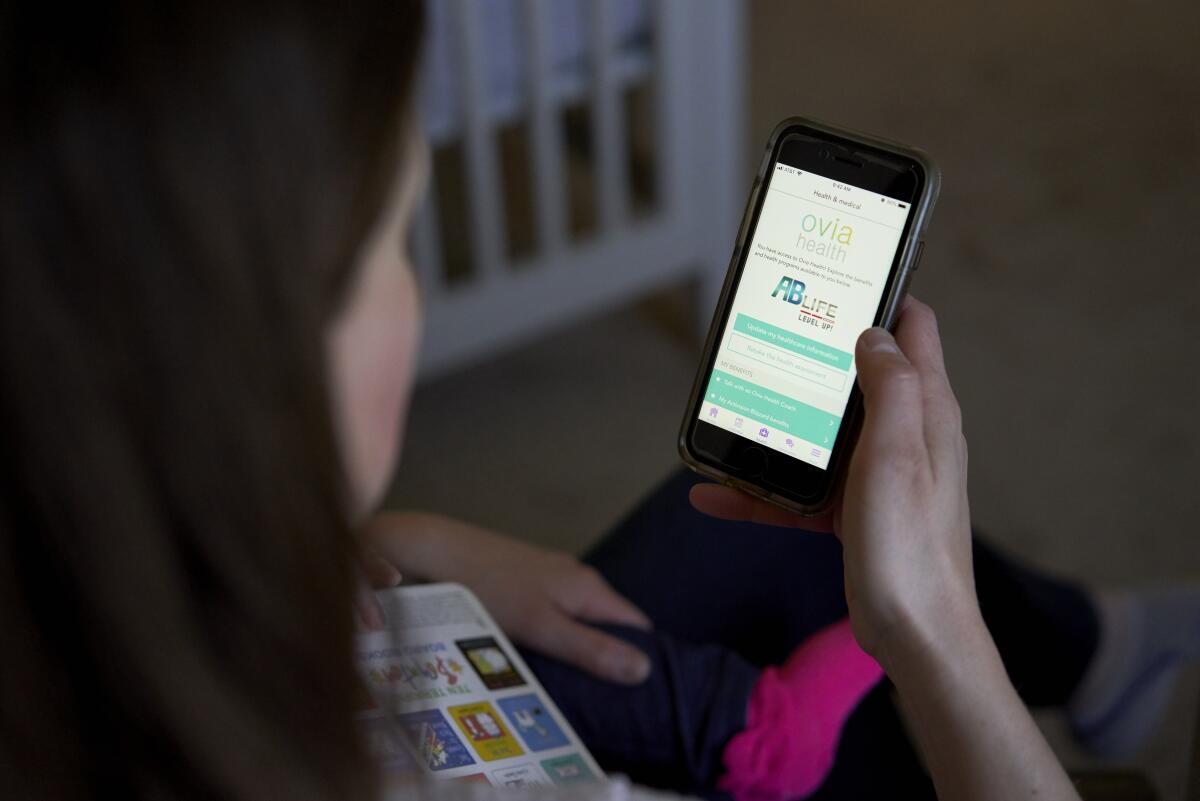 The Ovia pregnancy app is shown on a phone screen.