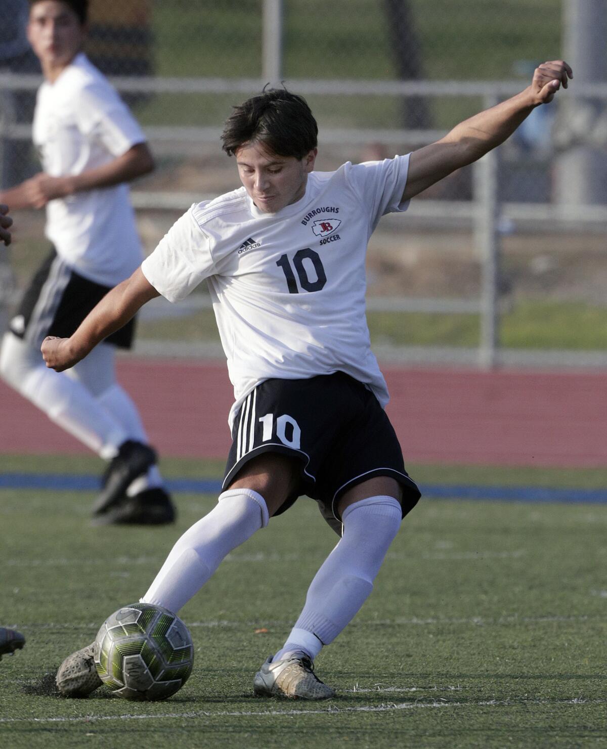 Burroughs' Juan Carlos Rosales shoots and scores against Muir in a Pacific League boys' soccer game at Muir High School in Pasadena on Tuesday, January 14, 2020.