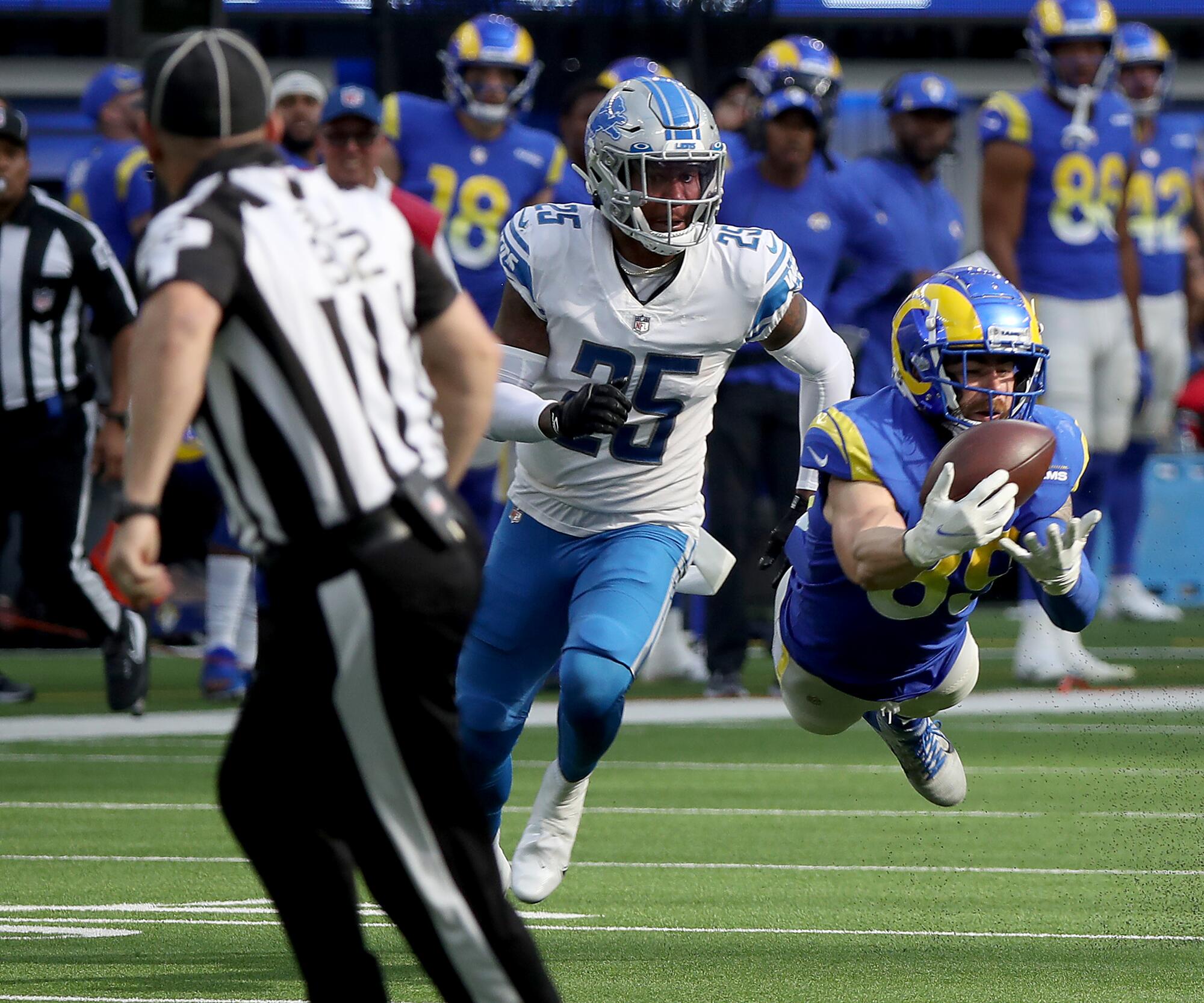 Rams tight end Tyler Higbee stretches out to catch a pass in front of Lions safety Will Harris in the fourth quarter.