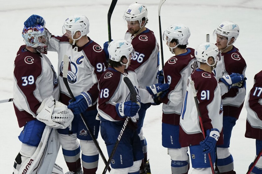 Colorado Avalanche goaltender Pavel Francouz (39) celebrates with teammates after the Avalanche defeated the Chicago Blackhawks 6-4 in an NHL hockey game in Chicago, Friday, Jan. 28, 2022. (AP Photo/Nam Y. Huh)