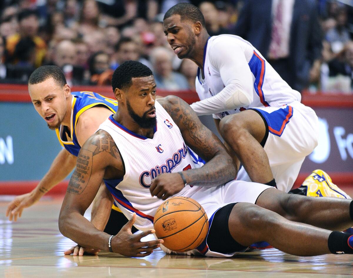 Clippers center DeAndre Jordan makes a key steal when he and teammate Chris Paul double-teamed Warriors guard Stephen Curry.