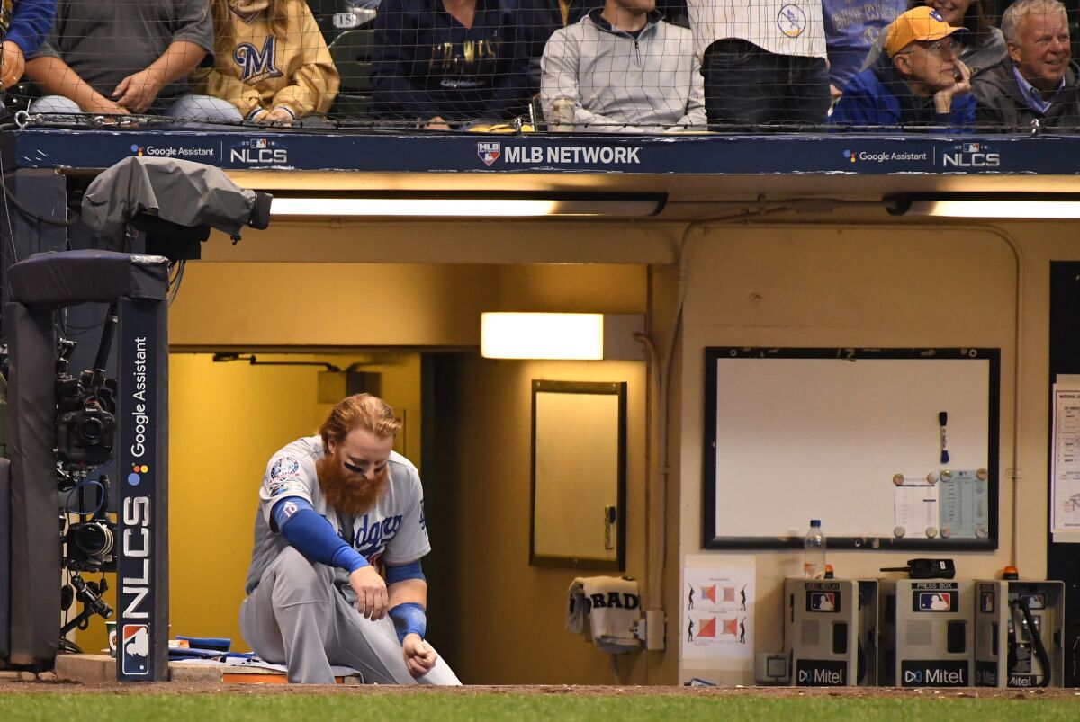 Dodgers Justin Turner sits in dugout after flying out in the 7th inning.