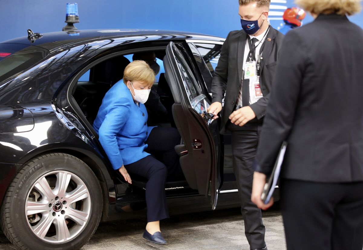 German Chancellor Angela Merkel arrives for an EU summit at the European Council building in Brussels, Saturday, July 18, 2020. Leaders from 27 European Union nations meet face-to-face for a second day of an EU summit to assess an overall budget and recovery package spread over seven years estimated at some 1.75 trillion to 1.85 trillion euros. (AP Photo/Olivier Matthys, Pool)