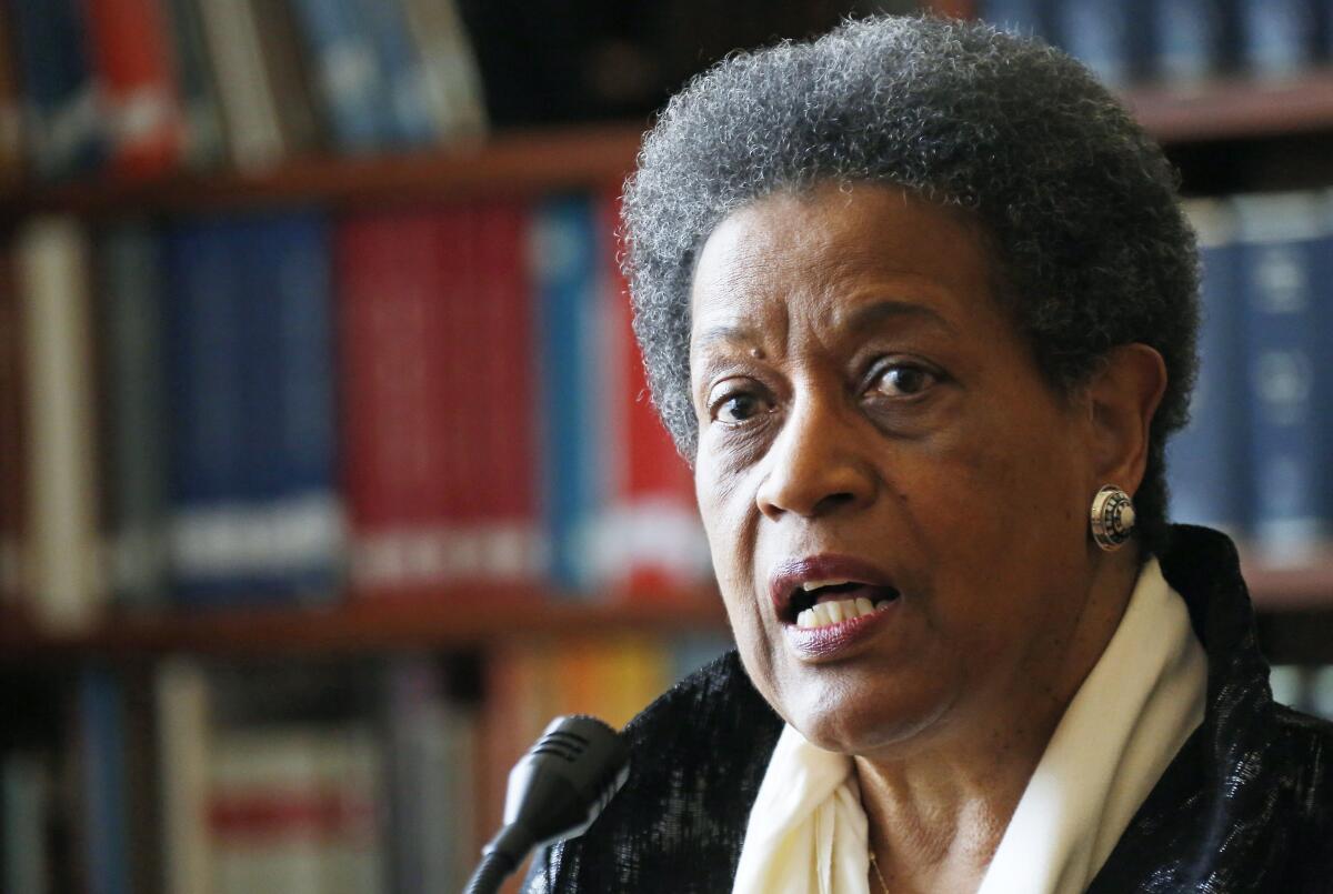 A head-and-shoulders image of Myrlie Evers-Williams speaking to a microphone. 