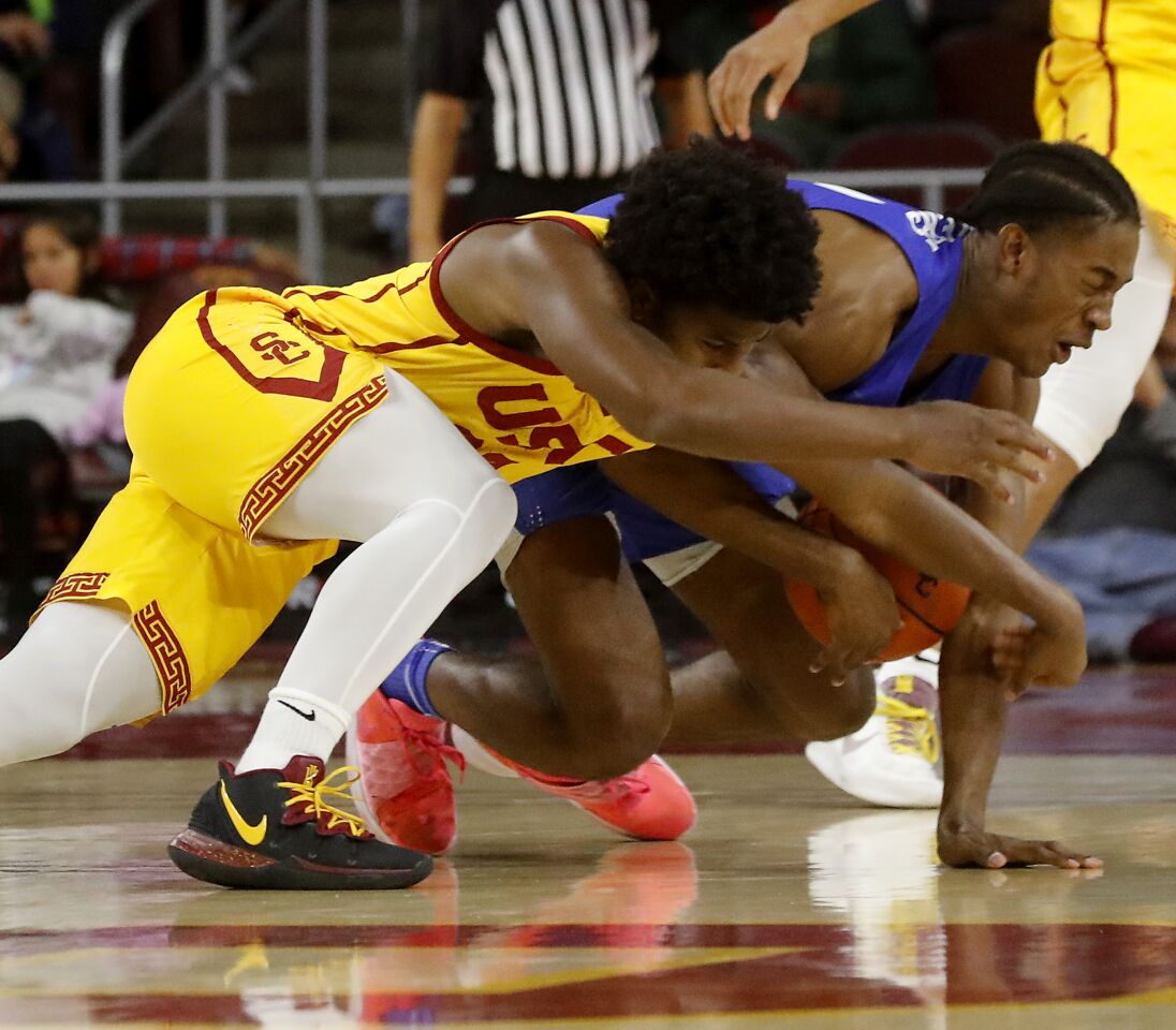 USC guard Ethan Anderson tries to steal the ball from Florida Gulf Coast forward Dakota Rivers during the second half.