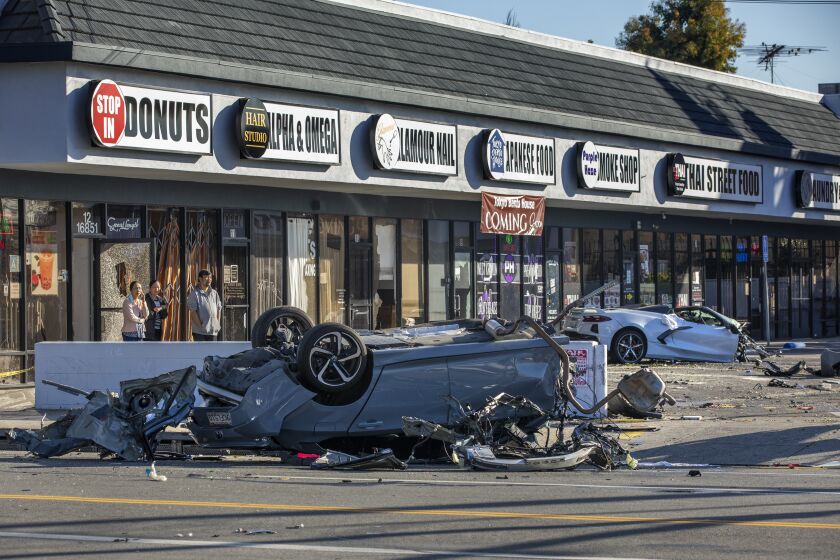 VAN NUYS, CA-FEBRUARY 8, 2023:Overall shows the scene of a crash involving a Honda Accord, left, and a Chevy Corvette, background, that ended up in a shopping center after crashing into a Honda Accord at the intersection of Balboa Blvd. and Victory Blvd. in Van Nuys. According to LAPD Sgt. Hector Gutierrez, at approximately 3:45 am this morning, the driver of the Corvette, a male, was traveling an estimated 90 to 100 mph, heading north on Balboa Blvd. and crashed into a Honda Accord, driven by a woman in her forties, traveling east on Victory Blvd. Both drivers of the cars died as a result. It is believed that the driver of the Corvette went through a red light. The passenger in the Corvette, a male, was taken to a hospital with severe injuries. There were no passengers in the Honda Accord. (Mel Melcon / Los Angeles Times)