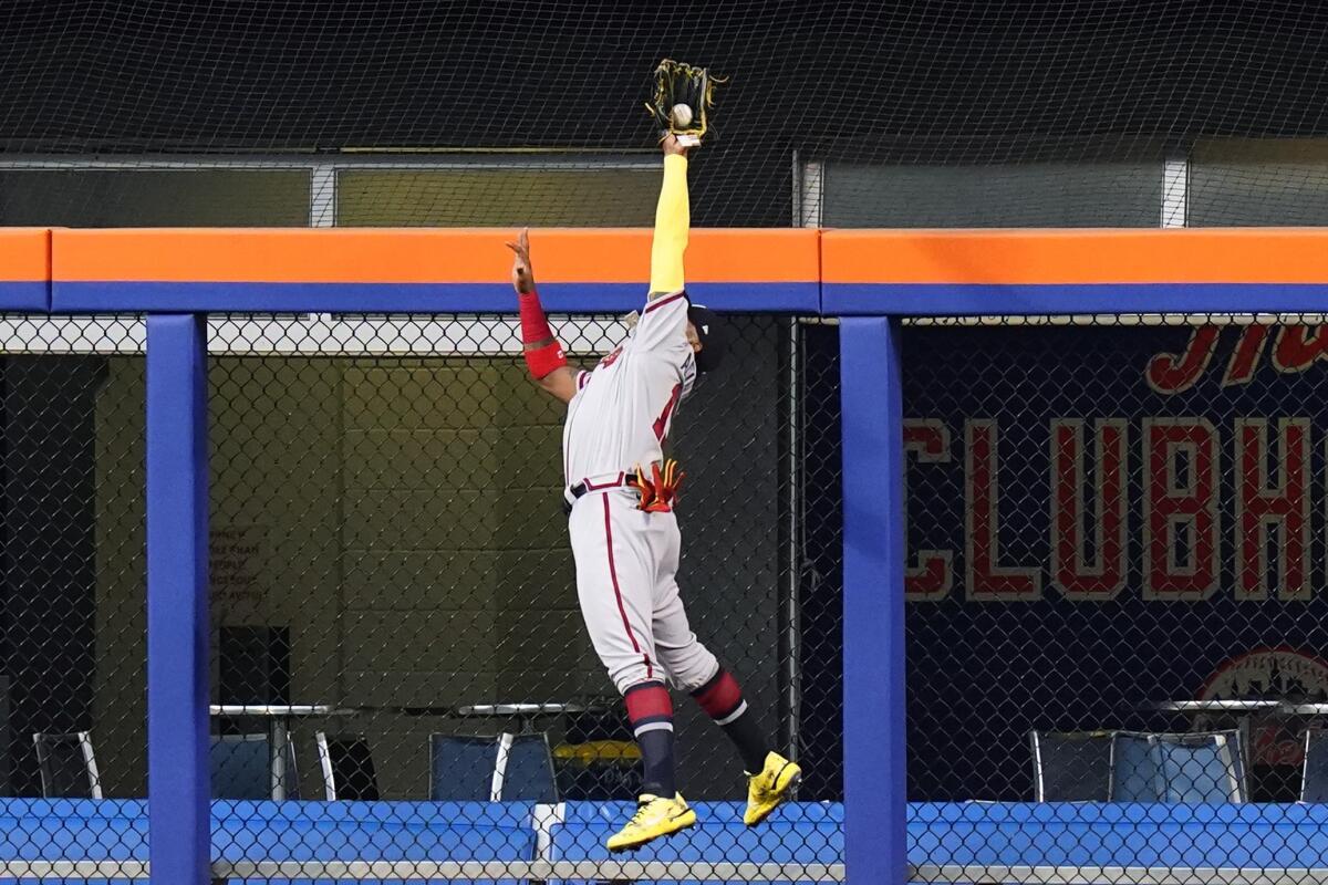 Atlanta Braves right fielder Ronald Acuna Jr. catches a fly ball hit by New York Mets' Pete Alonso at the wall to end the first inning of a baseball game Friday, Aug. 5, 2022, in New York. (AP Photo/Frank Franklin II)