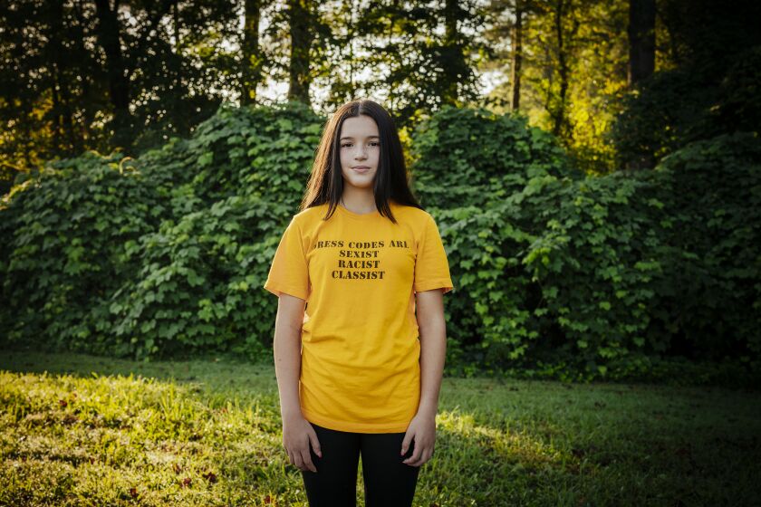 Sophia Trevino, 13, expresses her objection to dress codes by wearing a protest T-shirt to school every Friday, in Marietta, Ga. on Aug. 27, 2021. After being cited for a rip in her jeans on the first day of school, Trevino has led a protest seeking changes to the district's dress code, which she says unfairly targets girls. (Audra Melton/The New York Times)