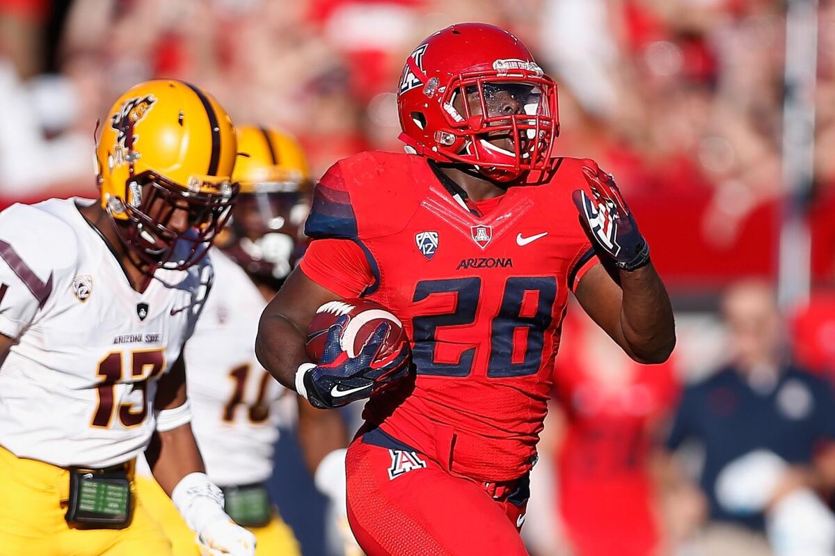 Arizona running back Nick Wilson breaks into the clear on a 72-yard touchdown run against Arizona State in the third quarter Friday.