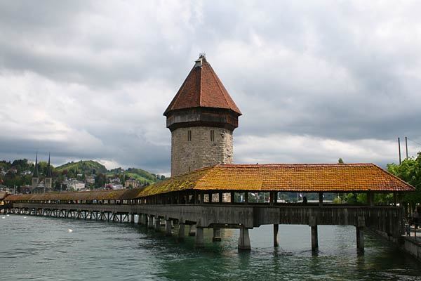 Despite centuries of wear and even a fire, Europe's oldest wooden bridge continues to charm tourists in Lucerne, Switzerland. The Chapel Bridge, which cuts diagonally across the Reuss River, was built in the early 14th century. About 300 years later, the bridge was adorned with a series of triangular paintings depicting events in the city's history. In 1993, fire nearly destroyed the bridge. It was largely restored in 1994. More photos...