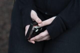 File - A teenager holds her phone as she sits for a portrait near her home in Illinois, on Friday, March 24, 2023. The U.S. Surgeon General is warning there is not enough evidence to show that social media is safe for young people — and is calling on tech companies, parents and caregivers to take "immediate action to protect kids now." (AP Photo Erin Hooley, File)