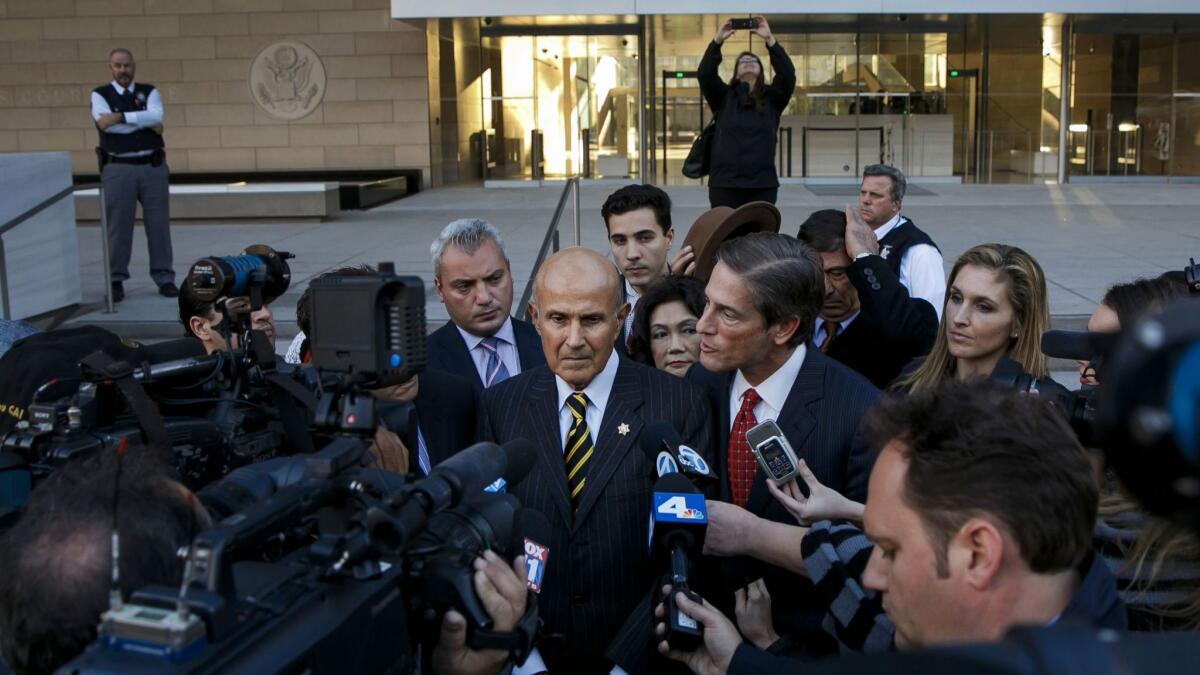 Former Los Angeles County Sheriff Lee Baca, left and attorney Nathan Hochman talk to reporters outside federal court Thursday, in downtown Los Angeles.