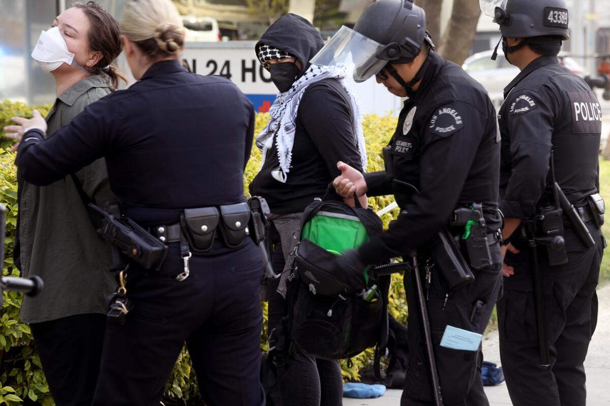 Protesters are arrested for trying to block traffic along Century Blvd. into LAX on Dec.27. 