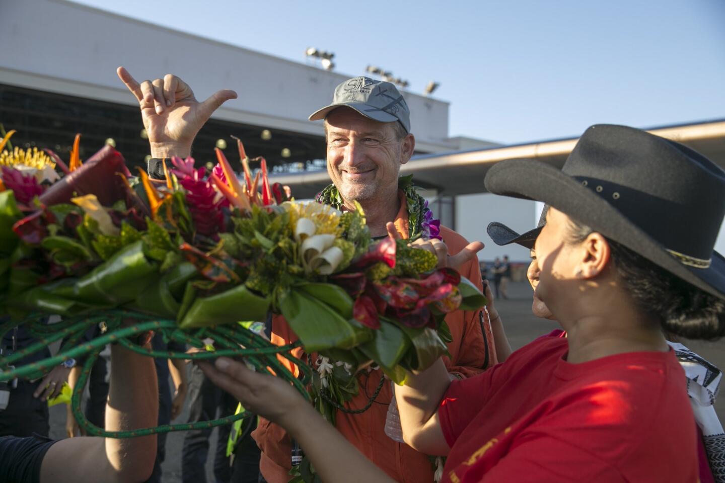 Pilot Andre Borschberg flashes a Hawaiian shaka at the crowd after he landed the Solar Impulse 2 at the Kalaeloa Airport in Kapolei, Hawaii, on Friday.