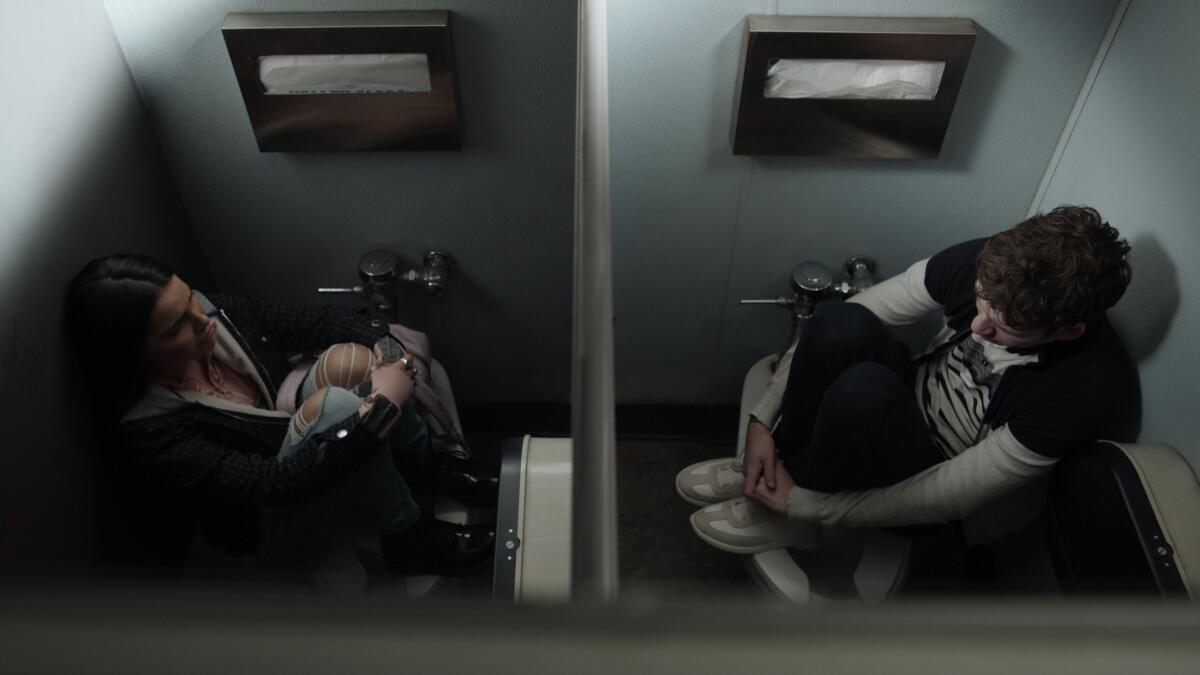 Students Estela de la Cruz (Inde Navarrette), Tyler Down (Devin Druid) hide amid an active-shooter drill in "13 Reasons Why."