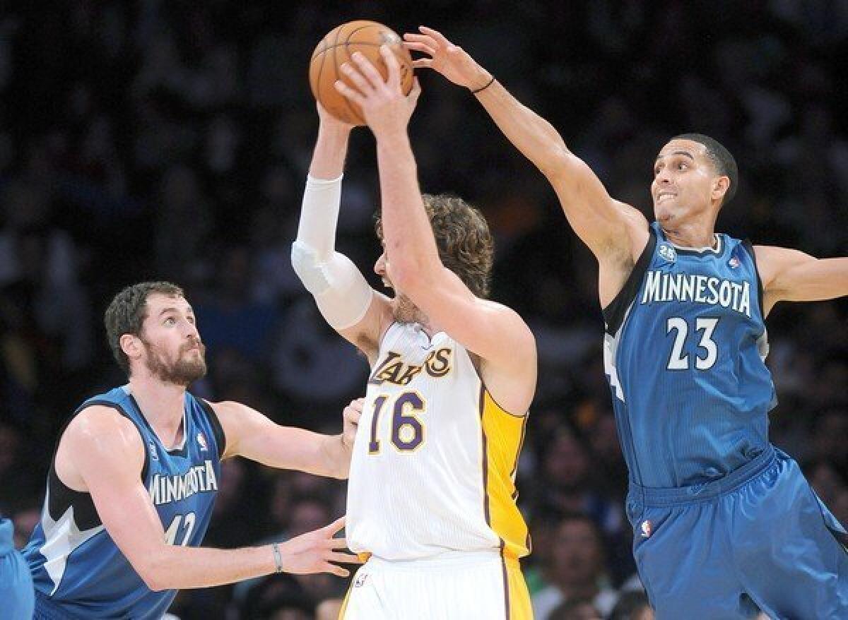 Lakers forward Pau Gasol, center, is double-teamed by Minnesota Timberwolves forward Kevin Love, left, and Kevin Martin during the Lakers' 113-90 loss at Staples Center last month.