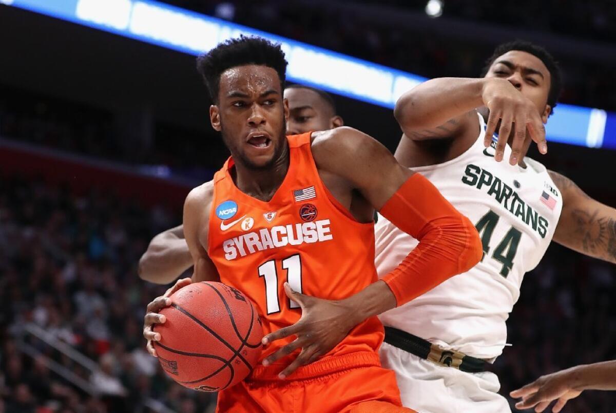 Syracuse's Oshae Brissett battles for the ball with Michigan State's Nick Ward during an NCAA tournament game on March 18.