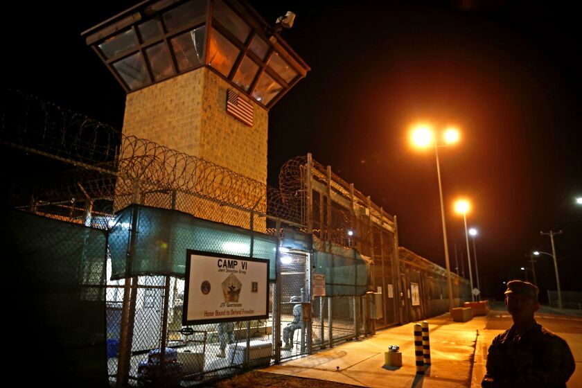 FILE - In this Nov. 20, 2013 file photo, reviewed by the U.S. military, the entrance to Camp VI detention facility is guarded at Guantanamo Bay Naval Base, Cuba. The Guantanamo Bay detention center would receive its first new prisoners in more than a decade under one option being considered as the U.S. withdraws its forces from Syria and works to resolve the fate of hundreds of captured suspected Islamic State fighters, officials say.(AP Photo/Charles Dharapak, File)