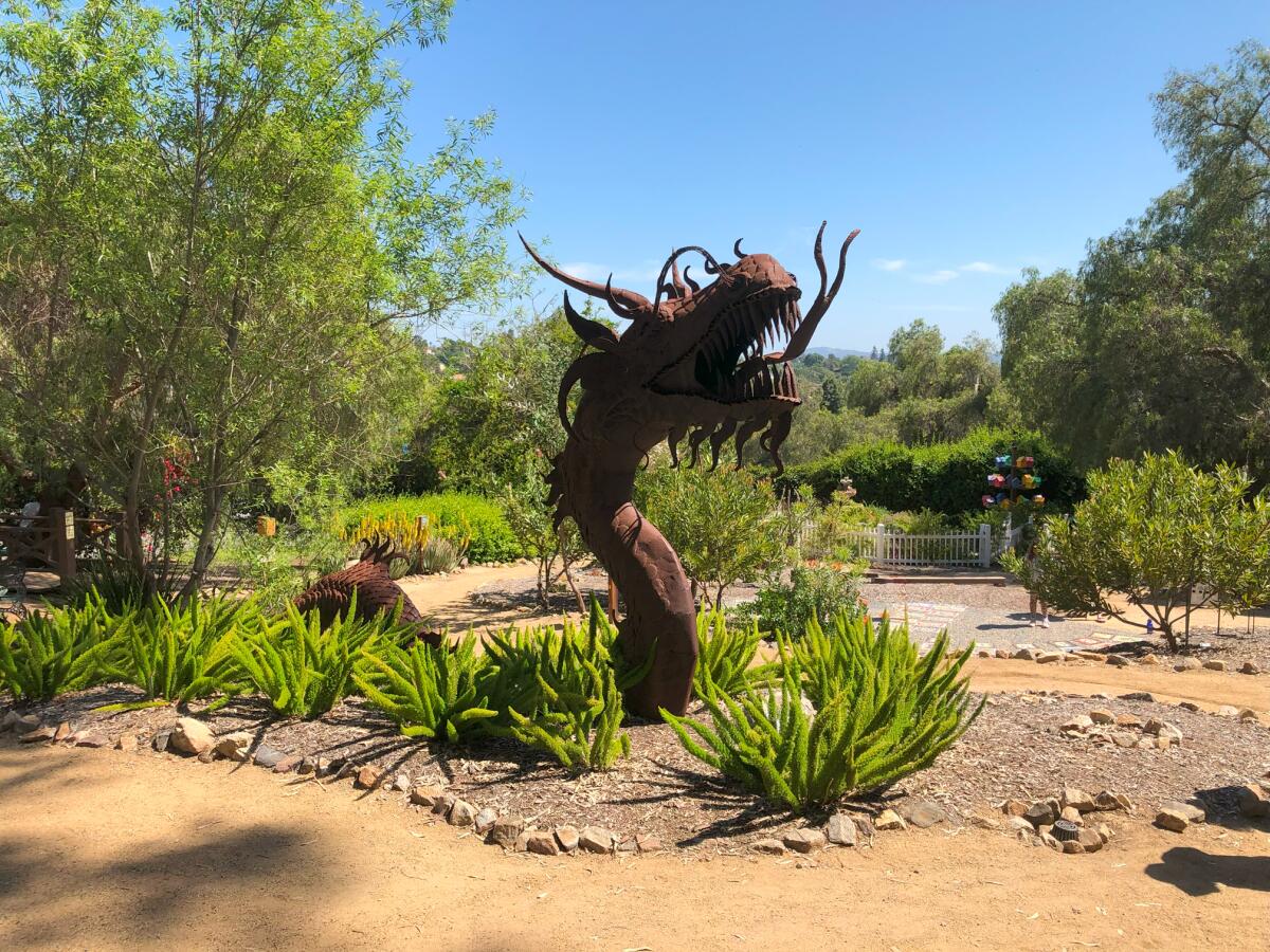 This baby dragon sculpture can be found at the Alta Vista Botanical Gardens.