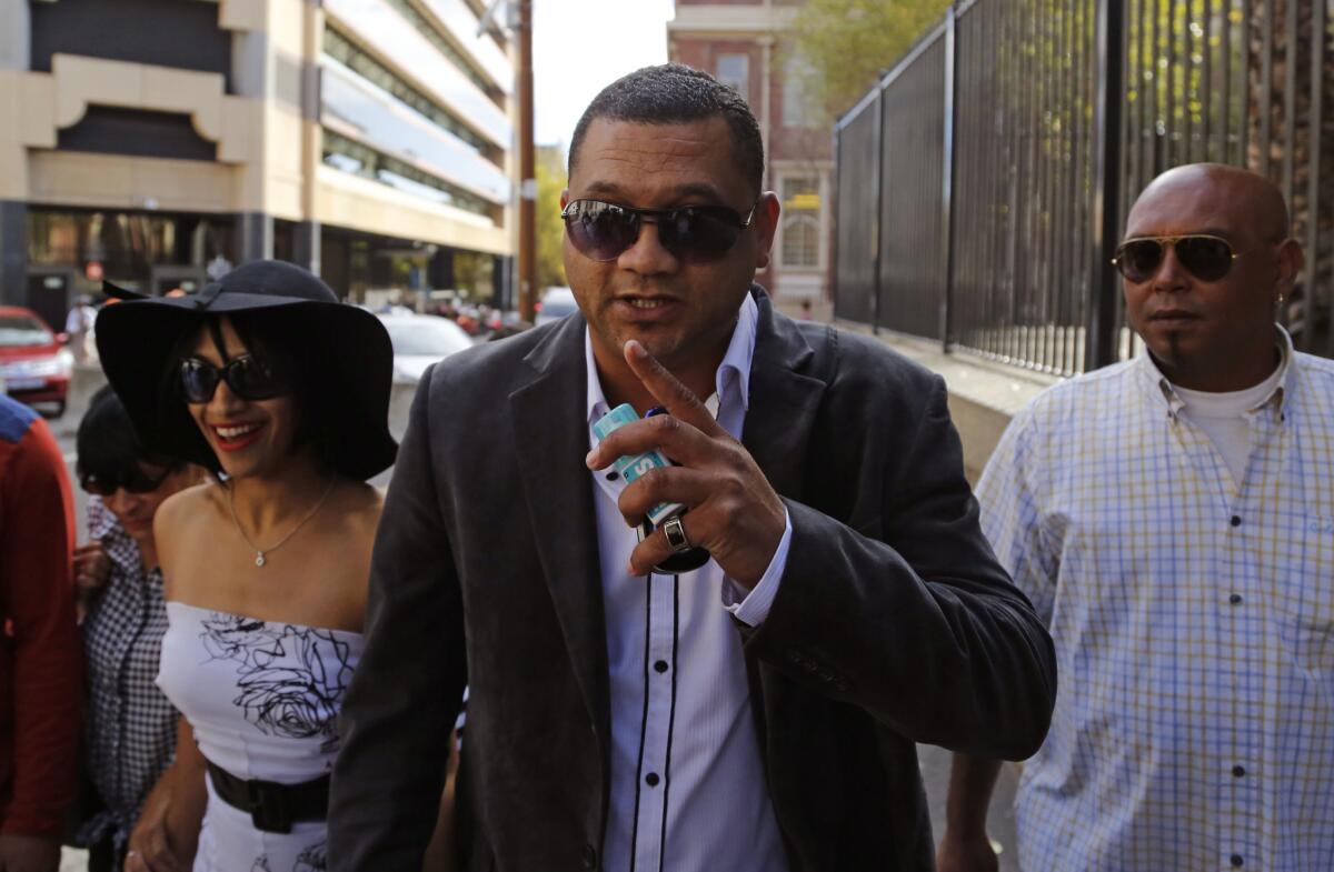 Morne Nurse, center, the father of a girl who was kidnapped as a newborn 17 years ago, and his wife, Celeste Nurse, left, arrive at court for the appearance of a woman suspected of the kidnapping in Cape Town, South Africa, on March 6.