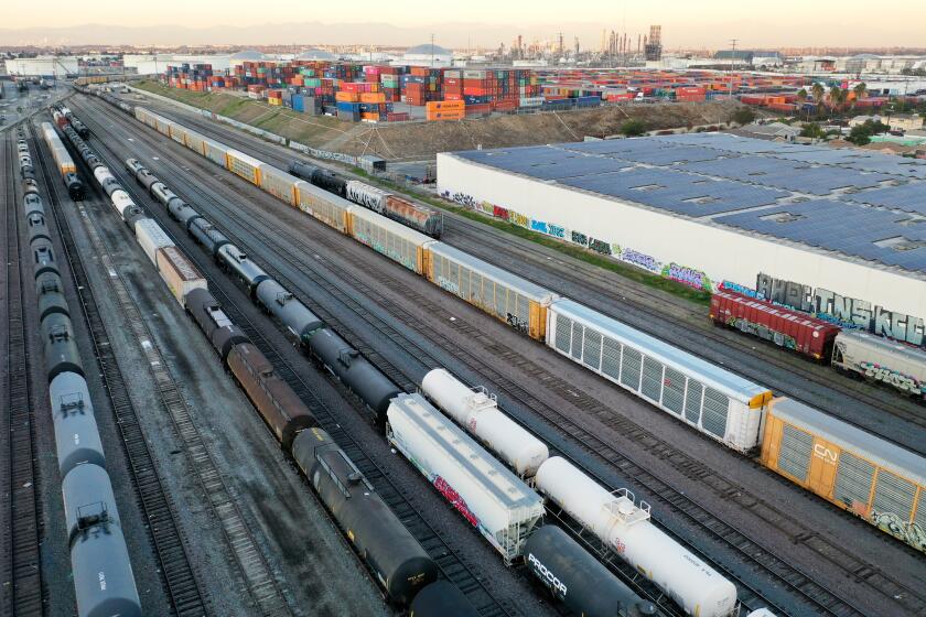 WILMINGTON, CALIFORNIA - NOVEMBER 22: In an aerial view, freight rail cars sit in a rail yard near shipping containers on November 22, 2022 in Wilmington, California. A national rail strike could occur as soon as December 5 after the nation’s largest freight rail union, SMART Transportation Division, voted to reject the Biden administration’s contract deal. About 30 percent of the nation’s freight is moved by rail with the Association of American Railroads estimating that a nationwide shutdown could cause $2 billion a day in economic losses. (Photo by Mario Tama/Getty Images)