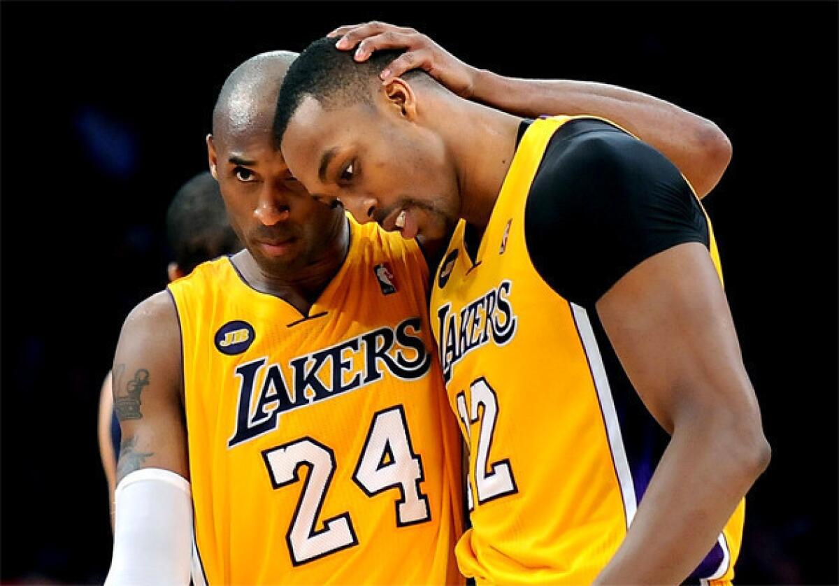Lakers guard Kobe Bryant (24) hugs center Dwight Howard after Howard made one of two free throws late in a game against the Memphis Grizzlies earlier this month.