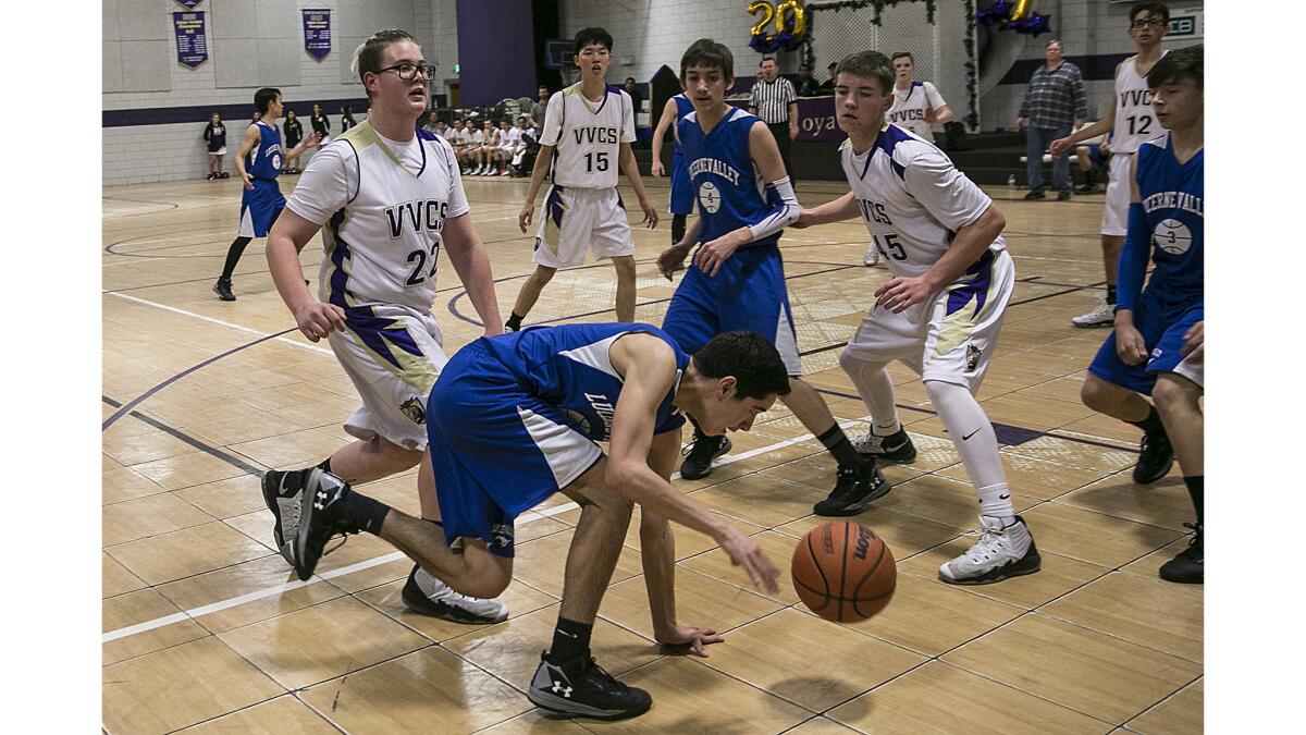 Lucerne Valley's Juan Cuevas tries to recover from a slip as he seeks to get to the basket against Victor Valley Christian.