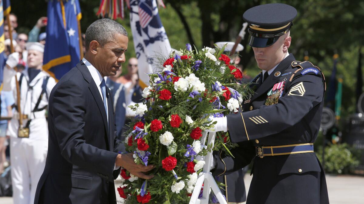 President Obama lays a wreath at the Tomb of the Unknowns at Arlington National Cemetery in Virginia on Memorial Day.