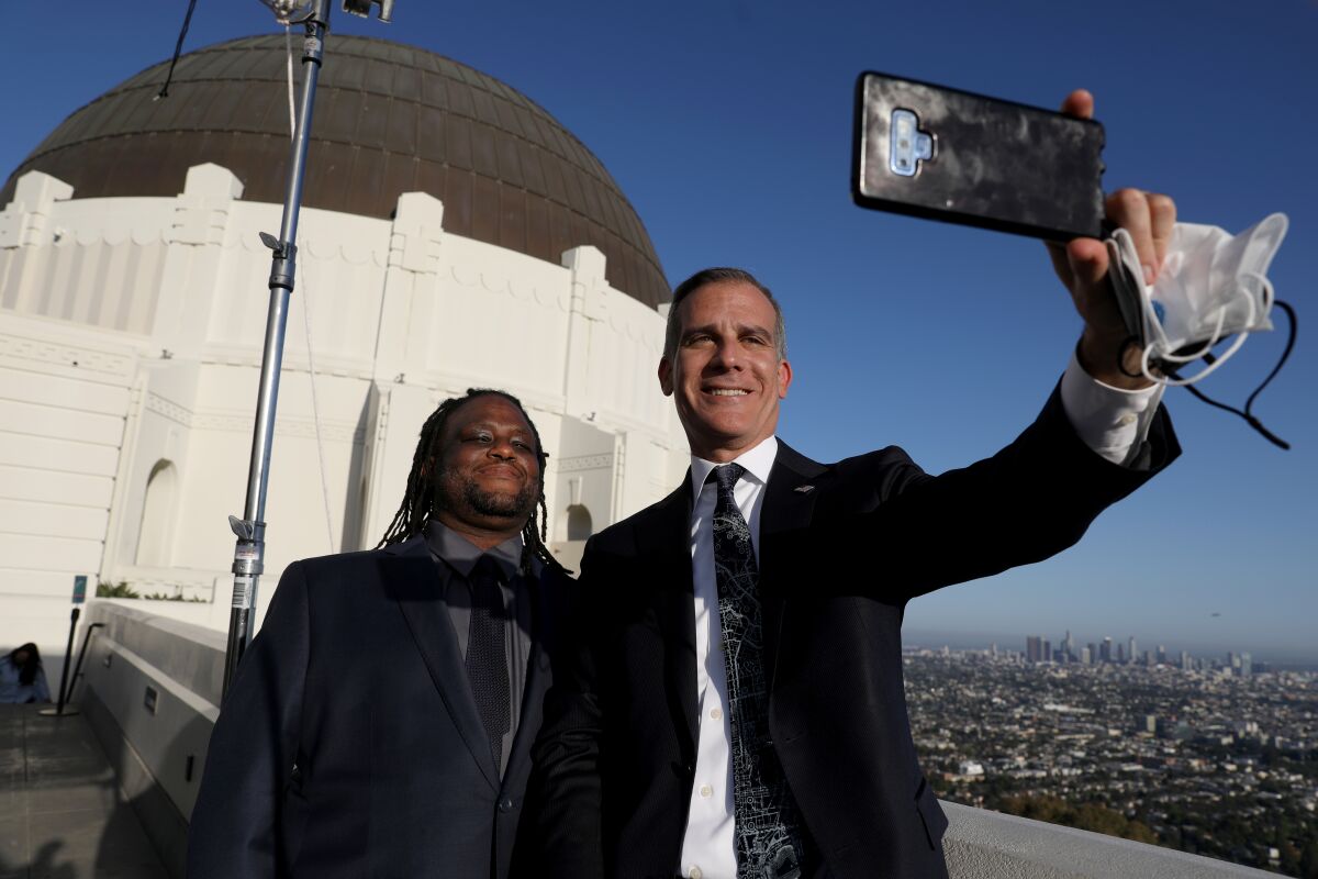 Mayor Eric Garcetti, right, takes a selfie with Andre Herndon.