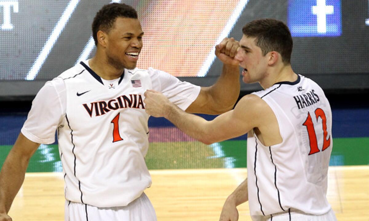 Virginia teammates Justin Anderson, left, and Joe Harris celebrate during the Cavaliers' victory over Pittsburgh in the semifinals of the Atlantic Coast Conference tournament on Saturday.