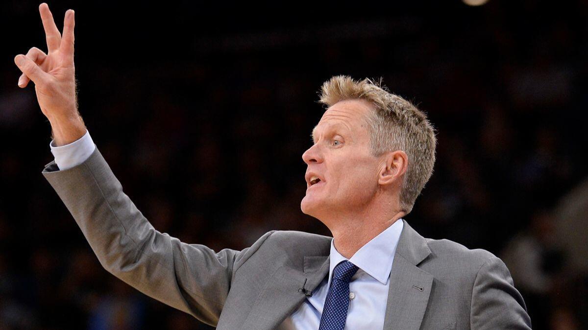 Golden State Warriors Coach Steve Kerr yells to his players during the first half against the San Antonio Spurs on March 11.