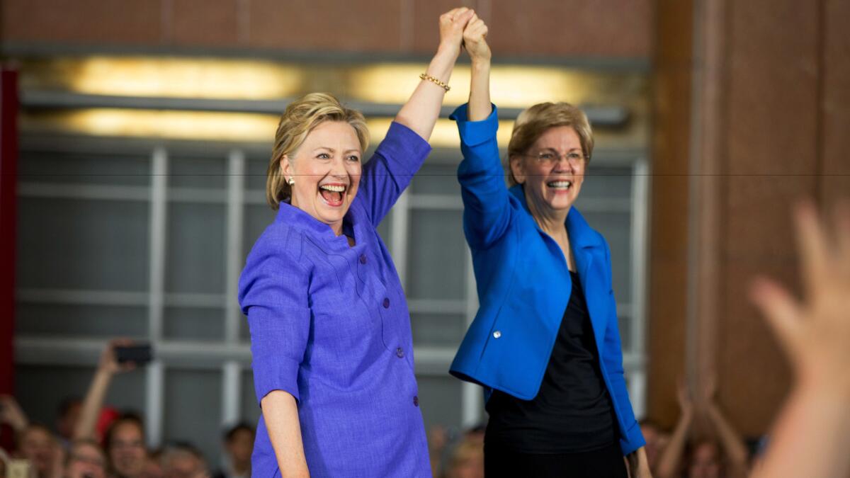 Hillary Clinton and Sen. Elizabeth Warren (D-Mass.), right, rally together in Cincinnati on Monday.