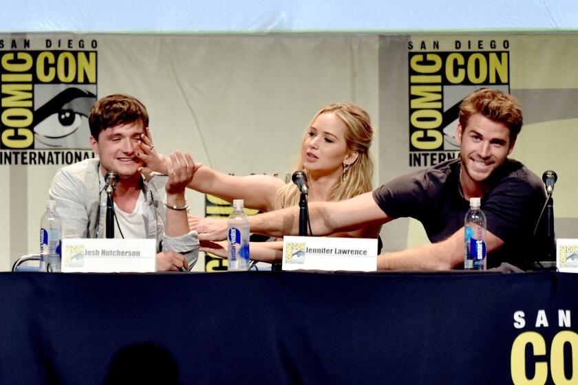 Actors Josh Hutcherson, Jennifer Lawrence and Liam Hemsworth speak at the "The Hunger Games: Mockingjay Part 2" panel during Comic-Con International 2015 at the San Diego Convention Center.