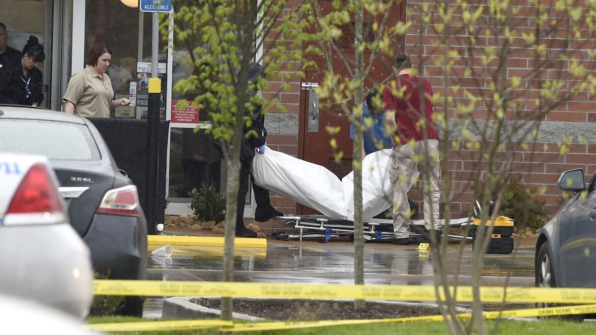 A body is carried out of Nashville Waffle House after a gunman killed four people on Sunday.