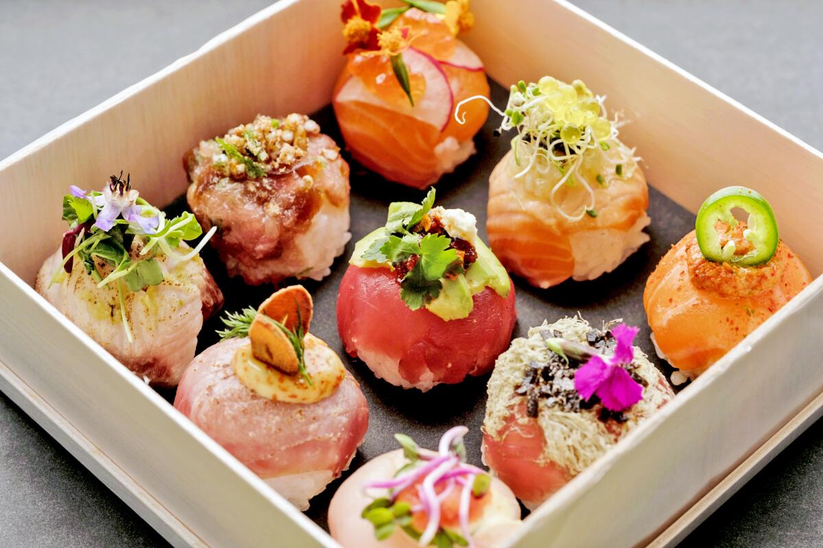 An assortment of DSCO Sushi's spherical, temari sushi in a white box