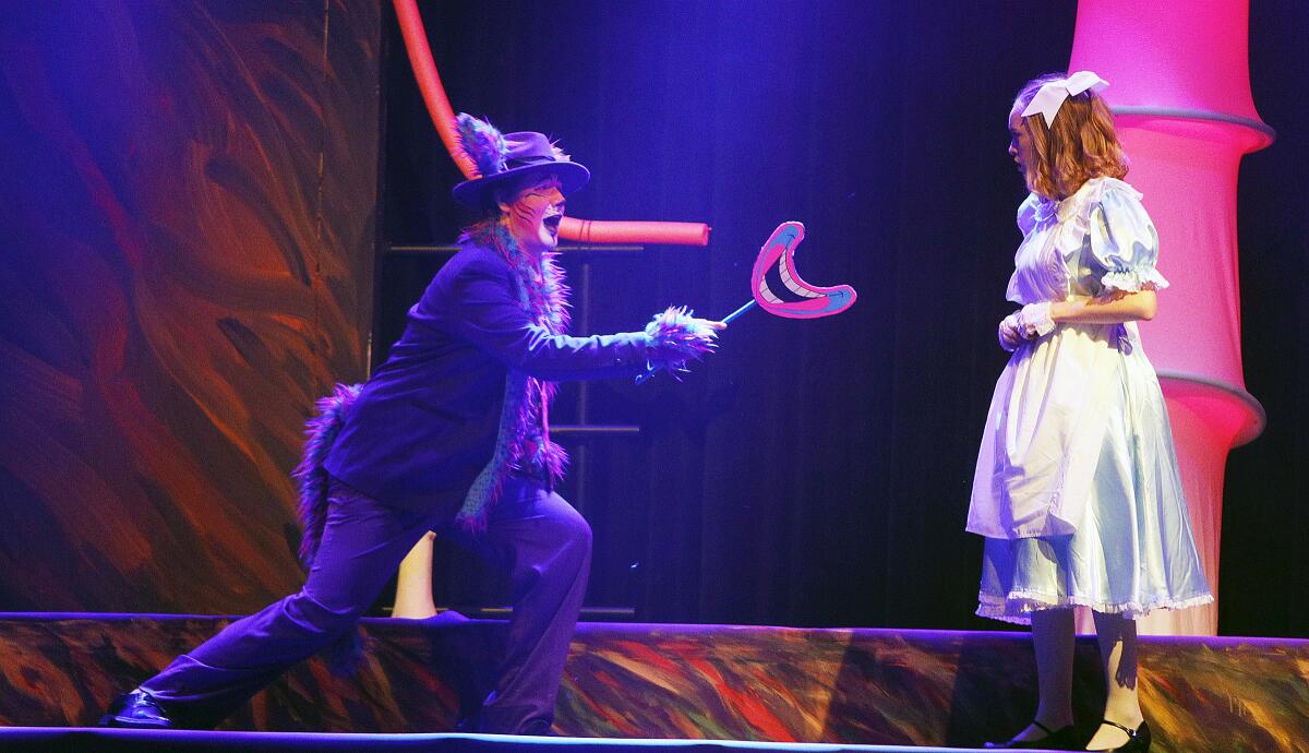 The Cheshire Cat (Harrison Rothacher) laughs during a scene with Alice (Abby Griffith) at the dress rehearsal of "Alice in Wonderland" at Burbank High on Tuesday.