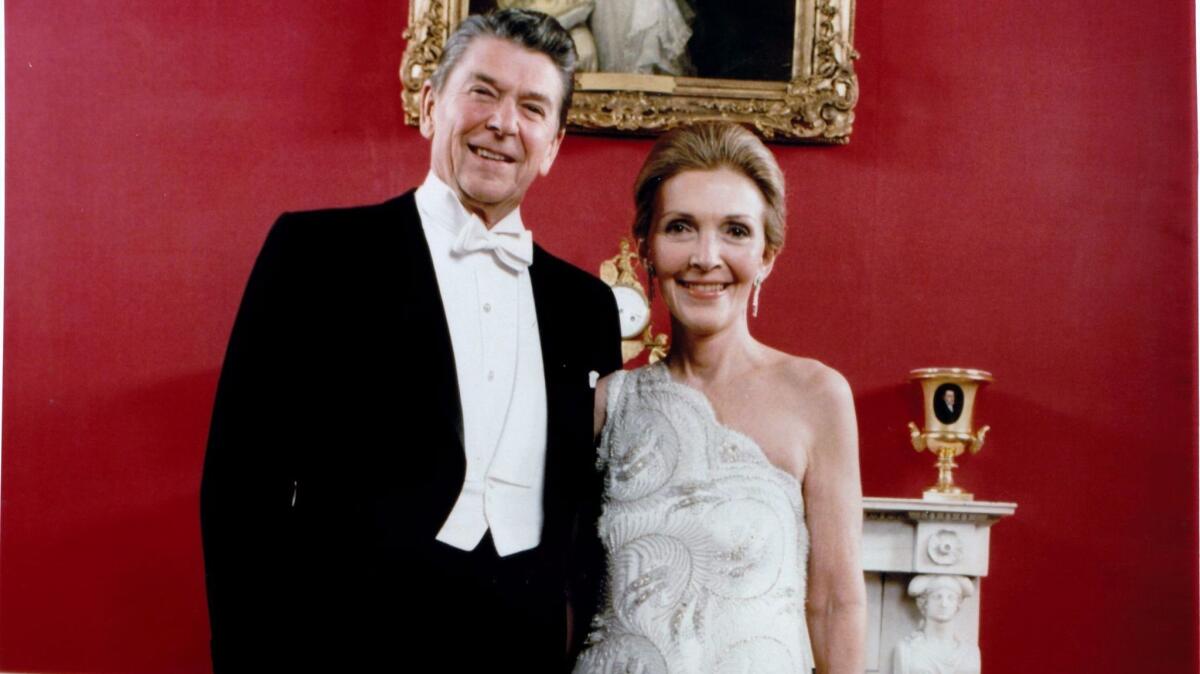 In a photo from the 1980s, former first lady Nancy Reagan, seen with President Ronald Reagan, wore a Galanos dress.